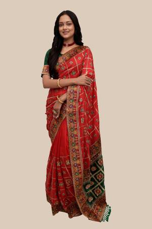 Celebrate This Festive Season In This Very Pretty Patola Designer Saree Paired With Contrasting Blouse. This Saree Are Soft Silk and Blouse Are Fentam Silk Based Beautified With Detailed Heavy Embroidery With Diamond Work And Latkan. 