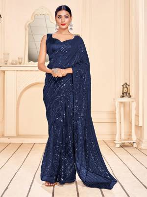 Garb This Party Wear Saree Are Fine Saree Paired With Matching Blouse.This Heavy Designer Sequance Embroidery Work Saree Is Faux Georgette Based And Blouse Are Art Silk Fabric. Which Gives A Rich Look To Your Personality. Buy This Pretty Saree Now.