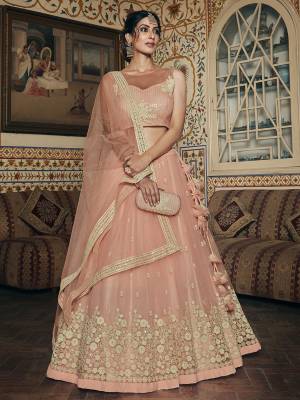 Look Attrective Bridal Partywear Heavy Designer Lehenga Choli And Dupatta In Lignt Color Fabricated On Net Beautified With Heavy Attractive Jari,Thread,Seaquance Embroidery. 