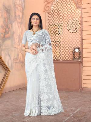 Garb This Partywear Saree Are Fine Saree Paired With Blouse.This Heavy Designer Thread Embroidery,Moti & Stone Work Saree And Blouse Are Net Based Fabric With Inner Satin. Buy This Pretty Saree Now.