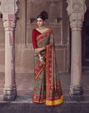 Garb This Partywear Saree Are Fine Saree Paired With Contrasted Blouse.This Saree And Blouse Are Patola Silk With Heavy Wevon Designer Work Based Fabric. Buy This Pretty Saree Now.