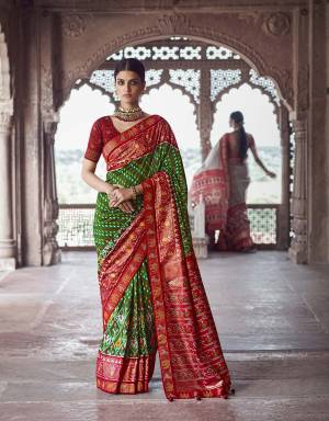 Garb This Partywear Saree Are Fine Saree Paired With Contrasted Blouse.This Saree And Blouse Are Patola Silk With Heavy Wevon Designer Work Based Fabric. Buy This Pretty Saree Now.