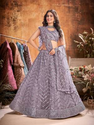 Garb This Partywear Heavy Designer Lehenga Choli And Dupatta In Fancy Color Fabricated On Soft Net Beautified With Heavy Attractive  Thread,Sequance Embroidery Work. 