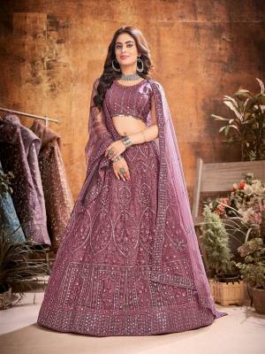 Garb This Partywear Heavy Designer Lehenga Choli And Dupatta In Fancy Color Fabricated On Soft Net Beautified With Heavy Attractive  Thread,Sequance Embroidery Work. 