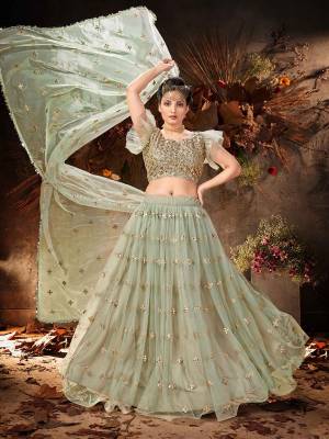 Garb This Partywear Heavy Designer Lehenga Choli And Dupatta In Fancy Color Fabricated On Soft Net Beautified With Heavy Attractive Mirror,Gota And Jari Embroidery Work. 