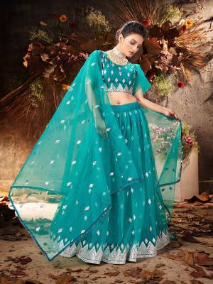 Garb This Partywear Heavy Designer Lehenga Choli And Dupatta In Fancy Color Fabricated On Soft Net Beautified With Heavy Attractive Mirror,Gota And Jari Embroidery Work. 