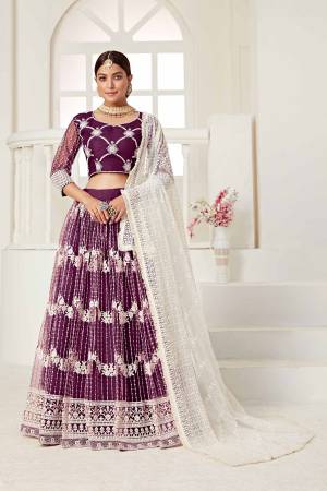 Garb This Partywear Heavy Designer Lehenga Choli And Dupatta In Fine Color Fabricated On Net Beautified Fabric With Designer Sequance,Cotton Thread Embroidery Work. 