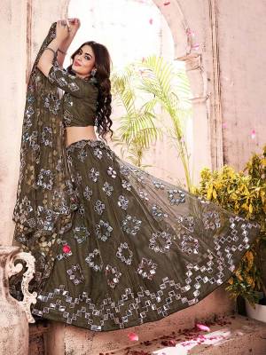 Garb This Partywear Heavy Designer Lehenga Choli And Dupatta In Fine Color Fabricated On Soft Net Beautified Fabric With Designer Thread,Foil,Mirror And Gota Embroidery Work. 