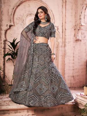 Garb This Partywear Heavy Designer Lehenga Choli And Dupatta In Fine Color Fabricated On Soft Net Beautified Fabric With Designer Thread,Foil,Mirror And Gota Embroidery Work. 