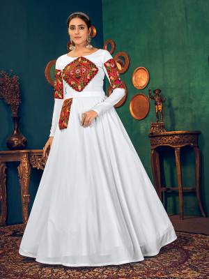 Flaunt Your Rich And Elegant Taste Wearing This Designer Long Gown In Light Color. This Pretty Gown Is Fabricated On Georgette Beautified With Real Mirror,Embroidery And Pearl Work. Its Fabric Is Soft Towards Skin And Easy To Carry All Day Long. 