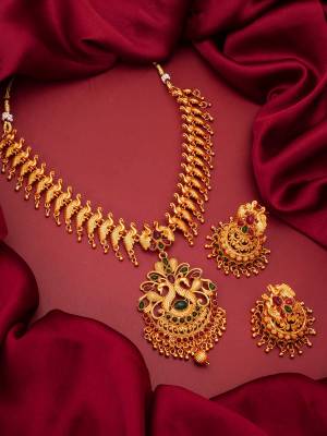 Heavy Looking To Your Personality By Pairing Up This Beautiful Necklace Set With Your Ethnic Attire. This Prtty Set Is In Gold Color Beautified With Temple Work. Buy Now.