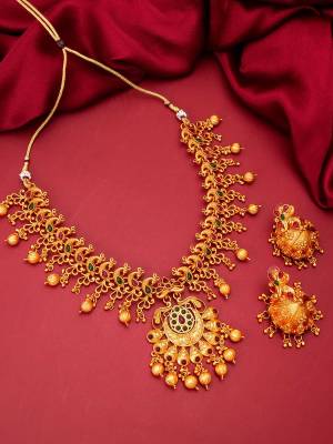 Heavy Looking To Your Personality By Pairing Up This Beautiful Necklace Set With Your Ethnic Attire. This Prtty Set Is In Gold Color Beautified With Temple Work. Buy Now.