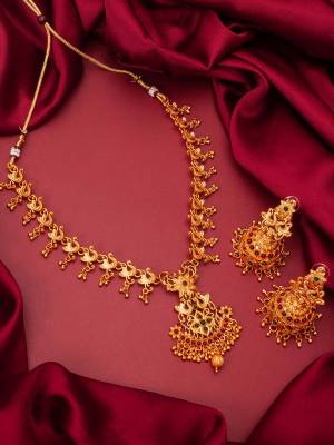 Heavy Looking To Your Personality By Pairing Up This Beautiful Necklace Set With Your Ethnic Attire. This Prtty Set Is In Gold Color Beautified With Temple Work. Buy Now.