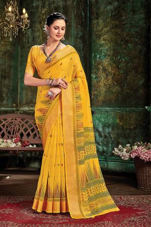 Garb This Traditional Saree Paired With Blouse.This Saree And Blouse Are Cotton Based Fabric With Wevon Designer Work. Buy This Pretty Saree Now.