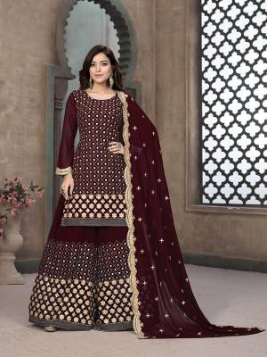 Stylist This Partywear Designer Sharara Suit In Lovely Dark Color.Its Pretty Heavy Designer Gota Embroidery Work Top Is Faux Georgette Based Paired With Santoon Bottom And Faux Georgette Fabricated Dupatta Which Gives An Attractive To The Suit.