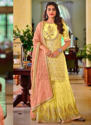 Here Is A Very Beautiful Designer Sharara Suit In Pretty Colored Top is Fabricated On Georgette Pair With Santoon Bottom And Georgette Dupatta Beautified With HHeavy Designer Sequance Embroidery Work