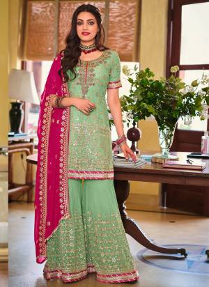 Here Is A Very Beautiful Designer Sharara Suit In Pretty Colored Top is Fabricated On Georgette Pair With Santoon Bottom And Georgette Dupatta Beautified With HHeavy Designer Sequance Embroidery Work