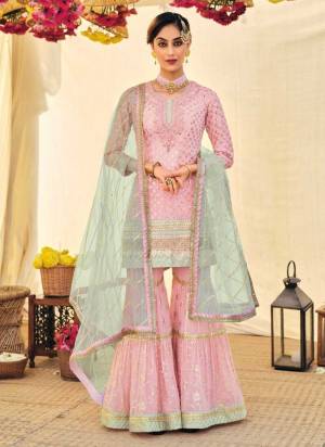 For A Designer Look,Grab These Sharara Suit in Fine Colored.These Top And Bottom Are Fabricated On Faux Georgette Pair With Soft Net Dupatta.Its Beautified With Heavy Designer Embroidery Work.