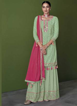 For A Designer Look,Grab These Sharara Suit in Fine Colored.These Top And Bottom Are Fabricated On Faux Georgette Pair With Faux Georgette Dupatta.Its Beautified With Heavy Thread,Mirror Embroidery Work.