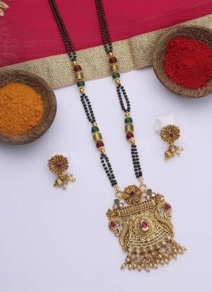 Grab These Beautifil Golden Colored Mangalsutra.These Earring is Come Mazzak Material And Beautified With Temple Work.