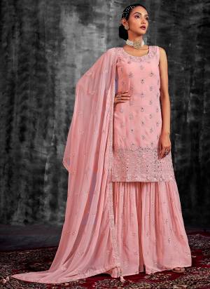 Garb These Readymade Sharara Suit in Fine Colored Pair With Bottom And Dupatta.These Top Are Georgette And Dupatta Are Fabricated On Georgette Pair With Georgette Bottom.Its Beautified With Heavy Designer Mirror,Thread,Jari Embroidery With Zarkan Work.