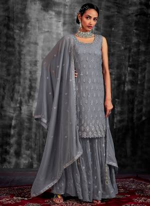 Garb These Readymade Sharara Suit in Fine Colored Pair With Bottom And Dupatta.These Top Are Georgette And Dupatta Are Fabricated On Georgette Pair With Georgette Bottom.Its Beautified With Heavy Designer Mirror,Thread,Jari Embroidery With Zarkan Work.