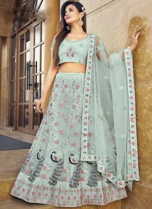 Garb This Partywear Fine Color Heavy Designer Lehemga Choli Fabric Are Soft Net And And Dupatta Soft Net In Fabricated Beautified With Attrective Reaham,Real Mirror Embroidery,Diamond Work. Buy Now.