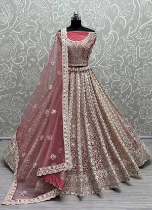 For A Fancy Designer Look,Grab These Lehenga Choli With Dupatta in Fine Colored.These Lehenga And Choli Are Net And Dupatta Are Fabricated On Soft Net Pair.Its Beautified With Hand Mirroe, Dori,Thread Embroidery,Zarkan Diamond Work.