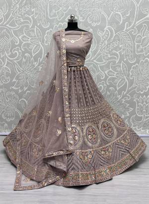 For A Fancy Designer Look,Grab These Lehenga Choli With Dupatta in Fine Colored.These Lehenga And Choli Are Net And Dupatta Are Fabricated On Soft Silk Pair.Its Beautified With Designer Thread,Sequance,Dori Embroidery,Zarkan Diamond Work.