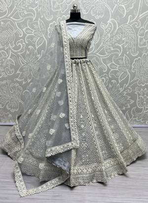 For A Fancy Designer Look,Grab These Lehenga Choli With Dupatta in Fine Colored.These Lehenga And Choli Are Net And Dupatta Are Fabricated On Soft Net Pair.Its Beautified With Designer Thread,Dori Embroidery, Diamond Work.