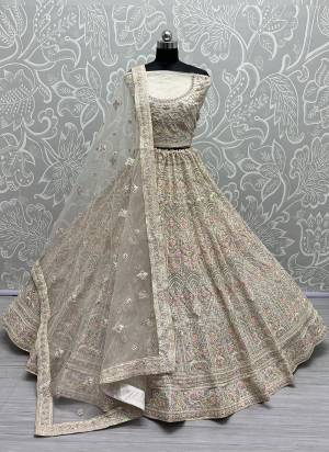 For A Fancy Designer Look,Grab These Lehenga Choli With Dupatta in Fine Colored.These Lehenga And Choli Are Net And Dupatta Are Fabricated On Soft Net Pair.Its Beautified With Designer Thread,Dori Embroidery, Diamond Work.