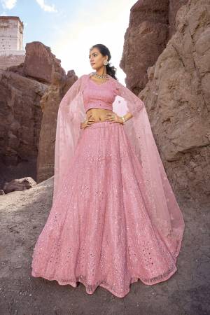 For A Designer Look,Grab These Lehenga Choli in Fine Colored.These Lehenga And Blouse Are Fabricated On Net Pair With Net Dupatta.Its Beautified With Designer Mirror Embroidery Cut Work With Zarkan Work.