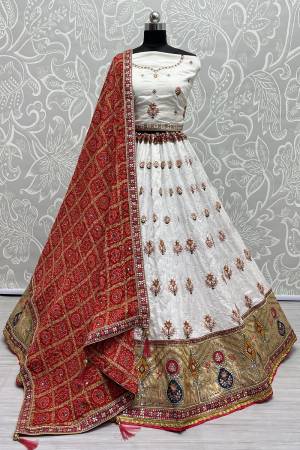 For A Fancy Designer Look,Grab These Lehenga Choli With Dupatta in Fine Colored.These Lehenga And Choli Are Gadhawal Silk And Dupatta Are Fabricated On Chiffon Pair.Its Beautified With Designer Printed,Jari Sequance Embroidery,Zarkan Diamond Work.