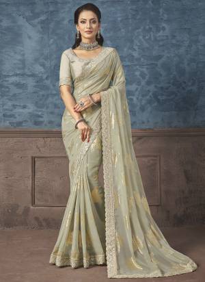 Look Attrective These Designer Party Wear Saree in Fine Light Colored.These Saree Are Georgette And Blouse Raw Silk is Fabricated.Its Beautified Heavy Wevon Designer With Embroidery Work.