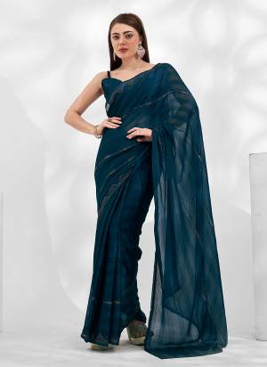 Garb These Fancy Saree in Fine Colored.These Saree Are Moss Chiffon And Blouse is Fabricated On Art Silk Pair.Its Beautified With Heavy Swarovski Work Wevon Patta Disigner.