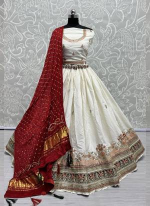 For A Fancy Designer Look,Grab These Lehenga Choli With Dupatta in Fine Colored.These Lehenga And Choli Are Gadhwal Silk And Dupatta Are Fabricated On Gajji Silk Pair.Its Beautified With Designer Hand Knitting Bandhej Dupatta With Cotton Thread Lakhnavi Embroidery Work.