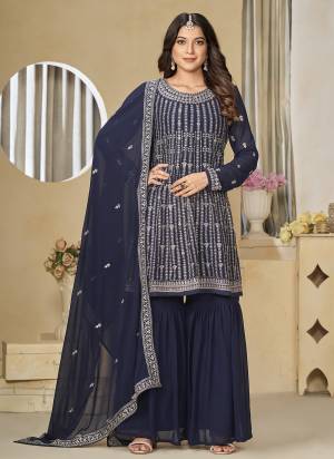 Garb These Party Wear Sharara Suit in Fine Colored Pair With Bottom And Dupatta.These Top And Dupatta Are Fabricated On Faux Georgette Pair With Santoon Bottom.Its Beautified With Santoon Inner.Its Beautified With Designer Heavy Embroidery Work.