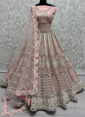 For A Fancy Designer Look,Grab These Lehenga Choli With Dupatta in Fine Colored.These Lehenga And Choli Are Net And Dupatta Are Fabricated On Soft Net Pair.Its Beautified With Designer Dori,Thread,Sequance Embroidery With Zarkan Diamond Work.