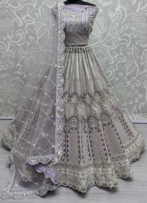 For A Fancy Designer Look,Grab These Lehenga Choli With Dupatta in Fine Colored.These Lehenga And Choli Are Net And Dupatta Are Fabricated On Soft Net Pair.Its Beautified With Designer Dori,Thread,Sequance Embroidery With Zarkan Diamond Work.