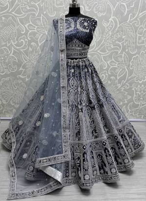 For A Fancy Designer Look,Grab These Lehenga Choli With Dupatta in Fine Colored.These Lehenga And Choli Are Velvet And Dupatta Are Fabricated On Soft Net Pair.Its Beautified With Designer Jari,Sequance,Thread Embroidery With Zarkan Diamond Work.