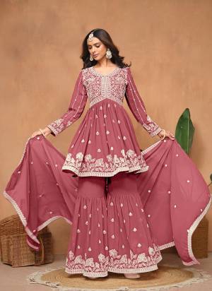 Garb These Party Wear Sharara Suit in Fine Colored Pair With Bottom And Dupatta.These Top And Dupatta Are Fabricated On Faux Georgette Pair With Faux Georgette Bottom.Its Beautified With Santoon Inner.Its Beautified With Designer Heavy Embroidery Work.