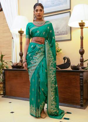 Take This Ethno Rich Satin Silk Fabric Saree With A Smooth, Lustrous Finish Intricate Zari Weaving That Adds A Touch Of Embossed Sophistication. This Classic Masterpiece Is Musthave For The Indian Wardrobe