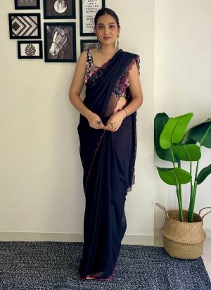 Grab This Beautiful Black Colour Solid Color Saree With Fancy Arco Border Work And Heavy Embroidery Sequins Work Blouse Fabricated On Faux Georgette Fabric For Elegant Party Looks. Have This Bollywood Style Saree For Glamorous Feels