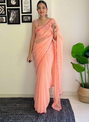 Grab This Beautiful Peach Colour Solid Color Saree With Fancy Arco Border Work And Heavy Embroidery Sequins Work Blouse Fabricated On Faux Georgette Fabric For Elegant Party Looks. Have This Bollywood Style Saree For Glamorous Feels