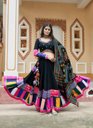 Grab This Beautifully Designed Chaniya Choli For The Coming Navratri Festive Season. This Black Colour Traditional Lehenga And Blouse Is Crafted On Viscose Rayon Fabric With Cotton Fabric Dupatta. This Pair Of Lehenga Choli Is Gracefully Designer With Ethnic Prints, Thread Embroidery With Mirror Work.