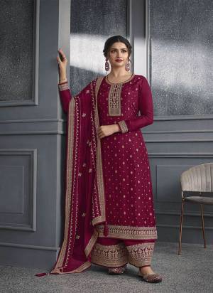 Wine colored Salwar suit is prettified with Embroidery work , Sequence Work and Diamond Work as shown which makes it appear classy. This top is made of Dola Silk fabric which is accompanied with Santoon bottom and Georgette dupatta. Women can buy this suit to wear for their parties and functions.