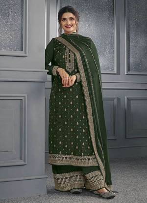 Green colored Salwar suit is prettified with Embroidery work , Sequence Work and Diamond Work as shown which makes it appear classy. This top is made of Dola Silk fabric which is accompanied with Santoon bottom and Georgette dupatta. Women can buy this suit to wear for their parties and functions.