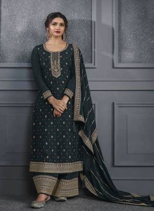 Grey colored Salwar suit is prettified with Embroidery work , Sequence Work and Diamond Work as shown which makes it appear classy. This top is made of Dola Silk fabric which is accompanied with Santoon bottom and Georgette dupatta. Women can buy this suit to wear for their parties and functions.