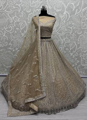 For A Fancy Designer Look,Grab These Lehenga Choli With Dupatta in Fine Colored.These Lehenga And Choli Are Net And Dupatta Are Fabricated On Net Pair.Its Beautified With Designer Sequance,Multy Thread Embroidery,Zarkan Diamond Work.