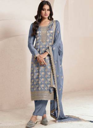Grey Colored Pakistani Suit is prettified with Embroidery work,Zari And Sequence Work as shown which makes it appear classy. This top is made of Jacquard fabric which is accompanied with Santoon Bottom,Santoon Inner and Chinon dupatta. Women can buy this suit to wear for their parties and functions.